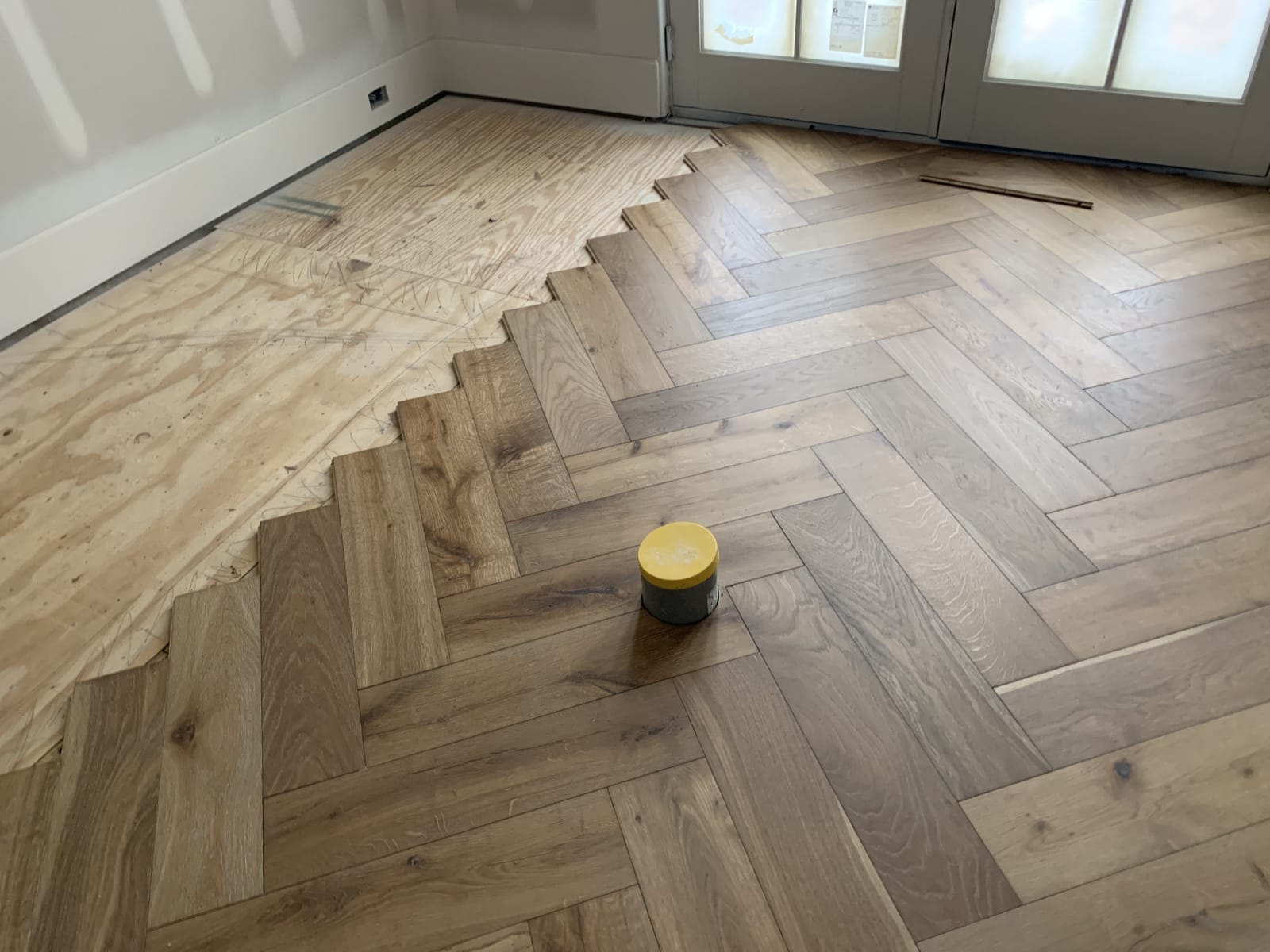 Herringbone floor going down, plank by plank