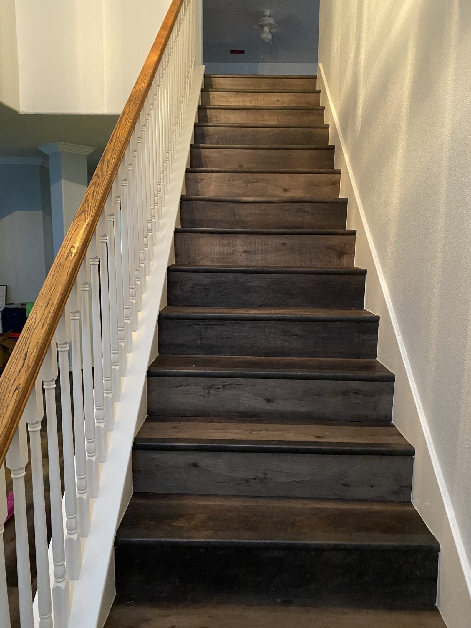 Plank-clad staircase with painted spindles