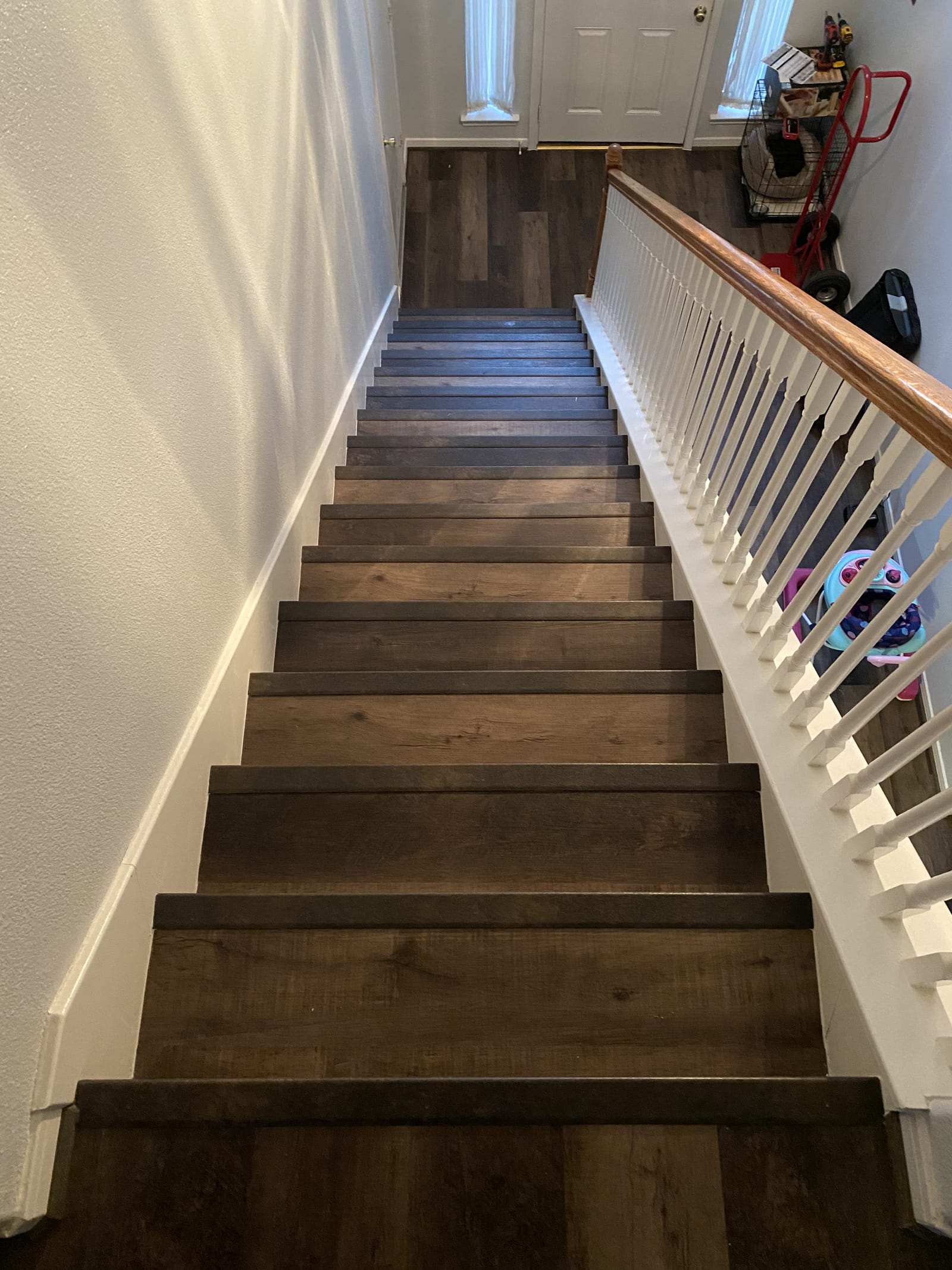 Hardwood staircase with white balusters