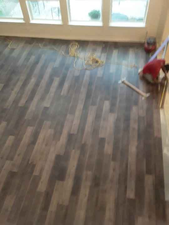 Gray plank going down, mid-install